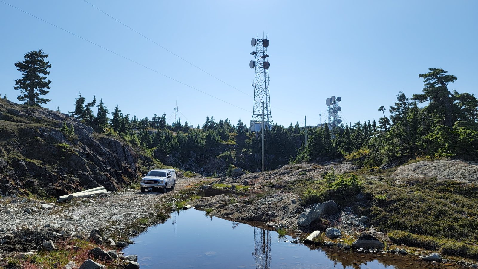 Remote lattice communications tower with sector and microwave antennas under inspection