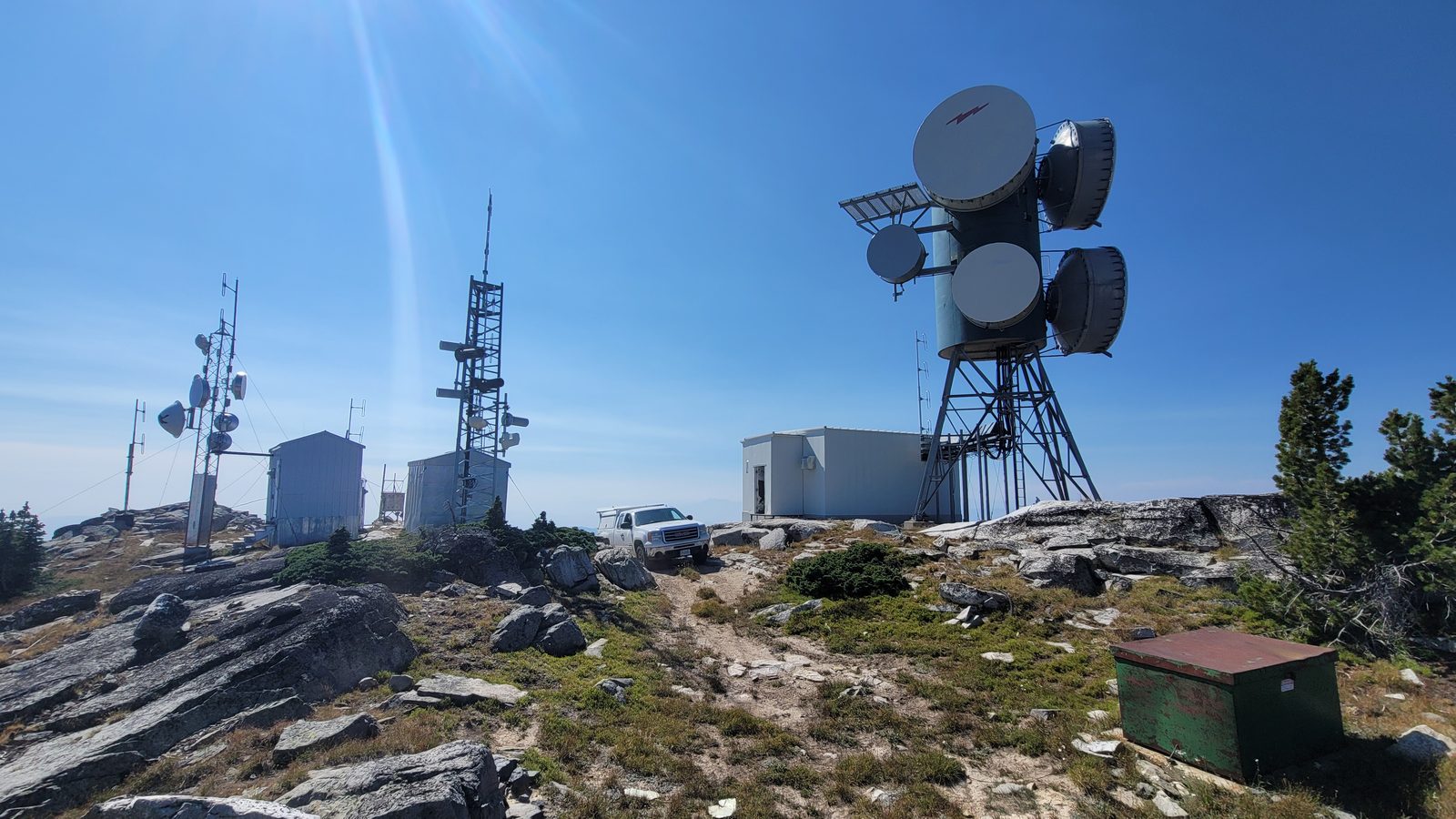 Mountain-summit microwave relay site with dish array on a lattice mast