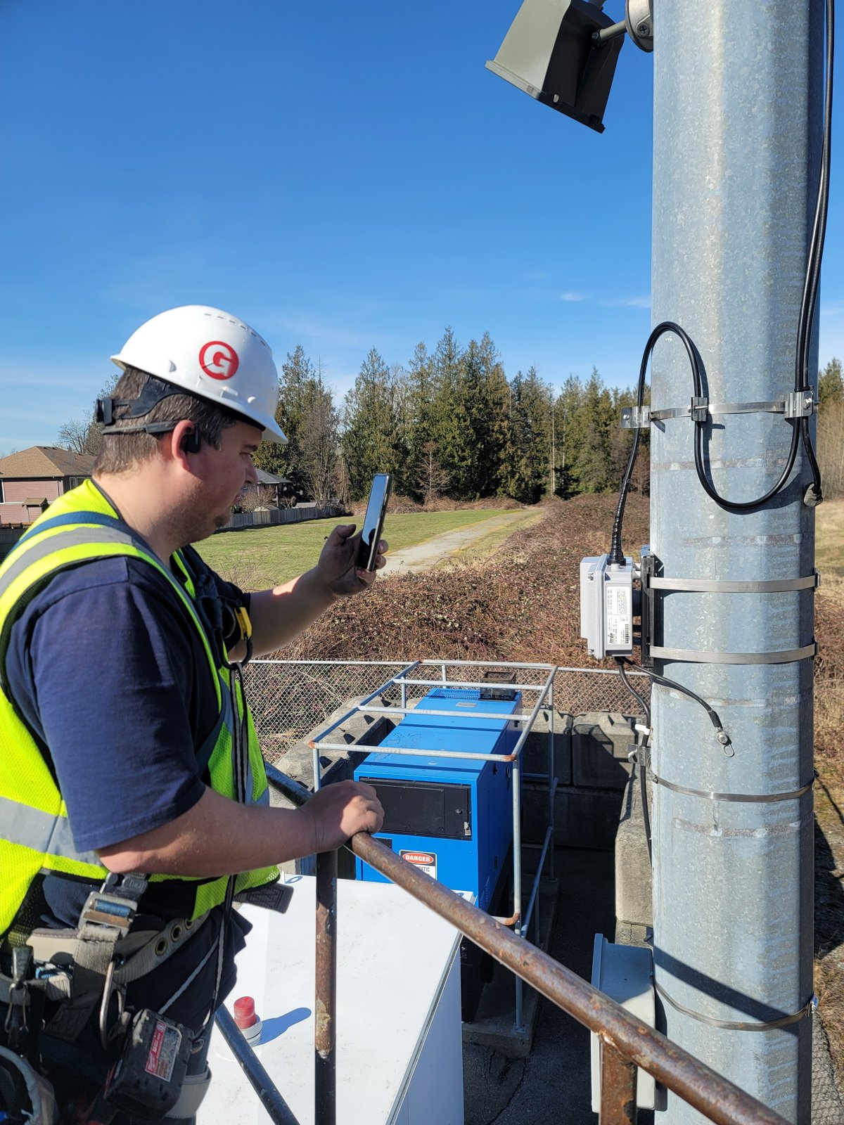 Tower technician secured on a self-supporting monopole at a rural telecom site